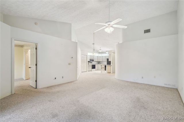 unfurnished living room with a textured ceiling, ceiling fan, light carpet, and high vaulted ceiling