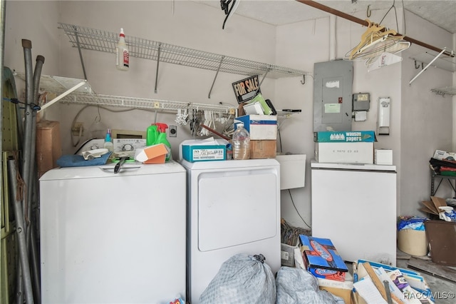 clothes washing area with electric panel and washer and clothes dryer