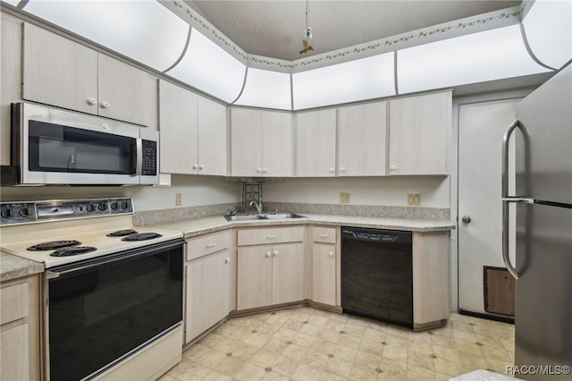 kitchen with a textured ceiling, light brown cabinets, sink, and stainless steel appliances