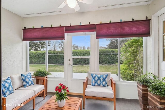 sunroom featuring ceiling fan