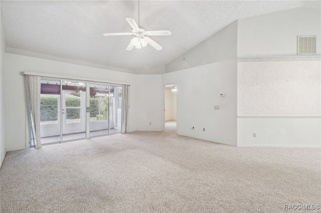 spare room featuring carpet flooring, vaulted ceiling, and ceiling fan