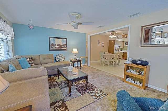 living room with ceiling fan, carpet, visible vents, and baseboards