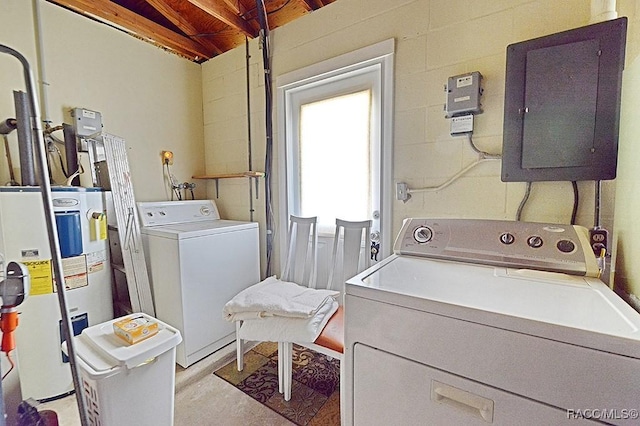 laundry room featuring laundry area, water heater, independent washer and dryer, electric panel, and concrete block wall