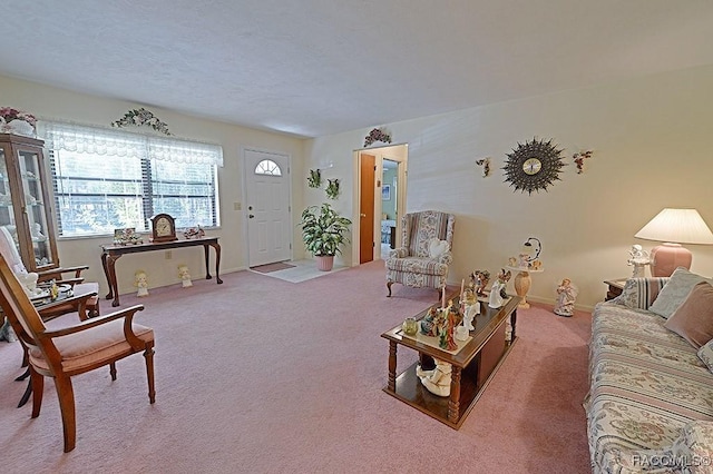 carpeted living room with baseboards