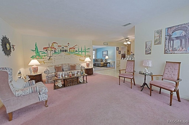 carpeted living room featuring ceiling fan and visible vents