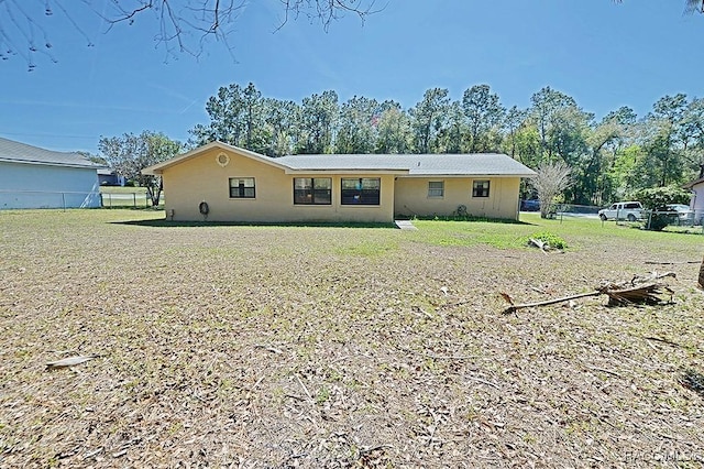 view of front of house with a front yard and fence