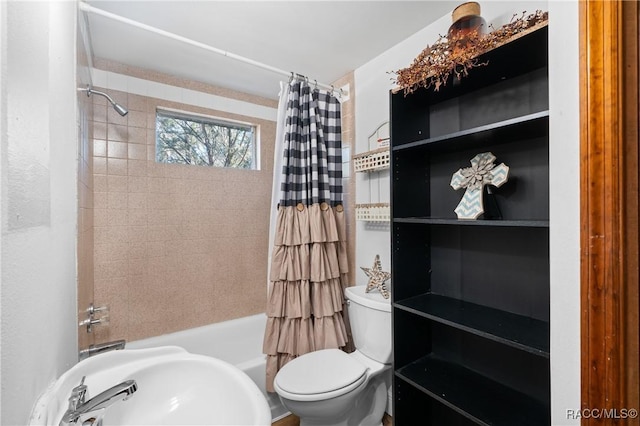 full bathroom featuring shower / bathtub combination with curtain, sink, and toilet