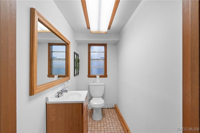 bathroom featuring tile patterned flooring, vanity, and toilet