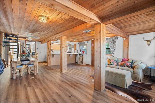 living room featuring hardwood / wood-style flooring, ceiling fan, wood ceiling, and beamed ceiling