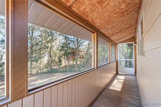 unfurnished sunroom with vaulted ceiling