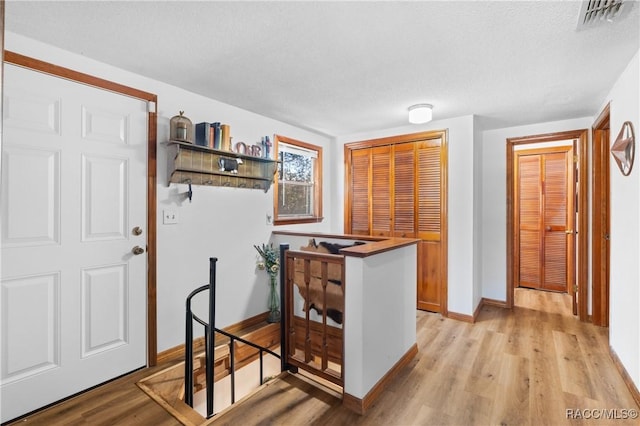 kitchen featuring light hardwood / wood-style floors and a textured ceiling