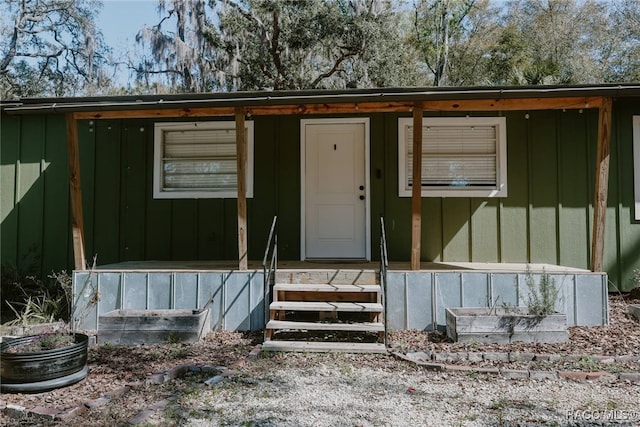 property entrance featuring board and batten siding