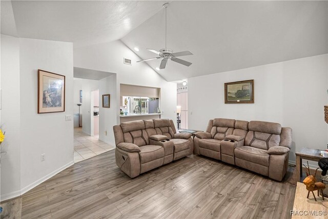 9530 SW 189th Ct, Dunnellon, FL 34432 - living area with a ceiling fan, light wood finished floors, high vaulted ceiling, and baseboards