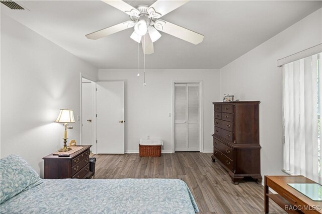 9530 SW 189th Ct, Dunnellon, FL 34432 - bedroom with wood finished floors, baseboards, a closet, and ceiling fan