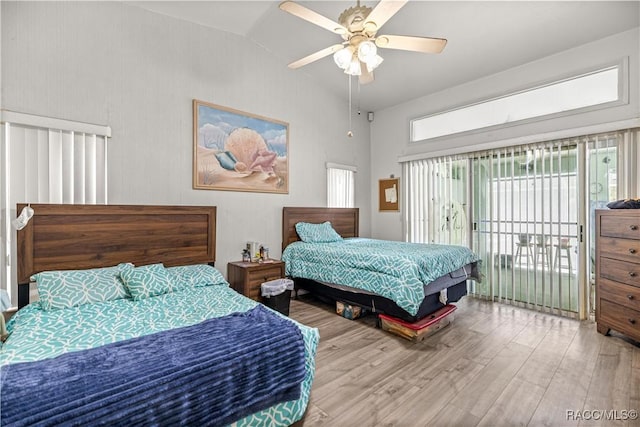 9530 SW 189th Ct, Dunnellon, FL 34432 - bedroom featuring access to exterior, wood finished floors, a ceiling fan, and high vaulted ceiling
