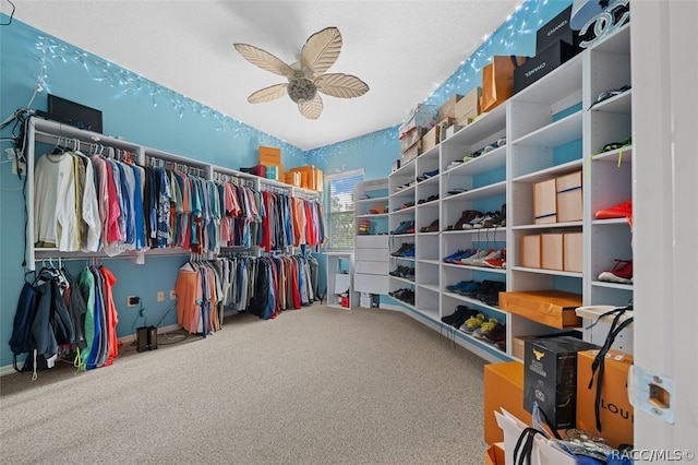 walk in closet with carpet floors and ceiling fan