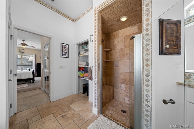 bathroom with ceiling fan and a shower with shower door