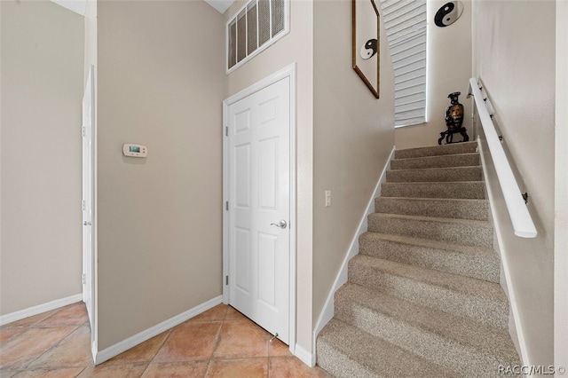 staircase featuring tile patterned floors