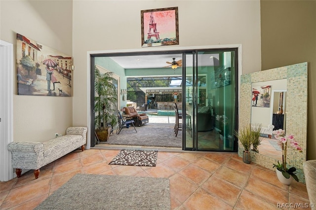 doorway with a high ceiling and ceiling fan