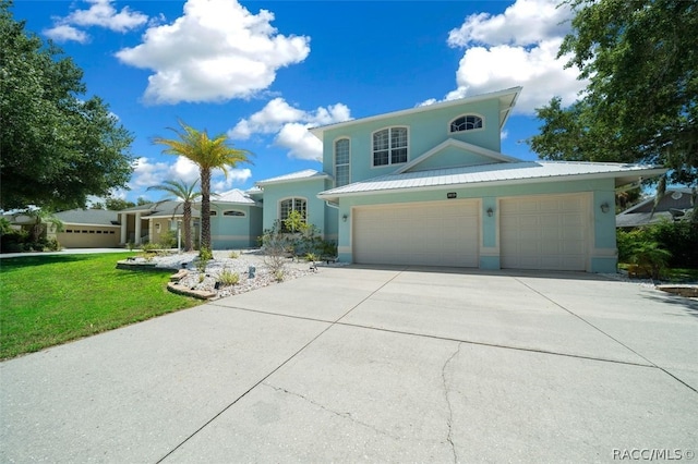 view of front of property with a garage and a front lawn