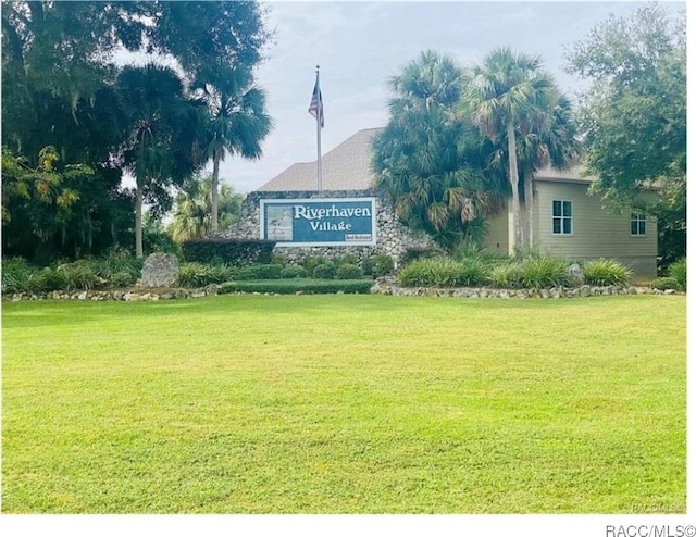 community sign featuring a yard