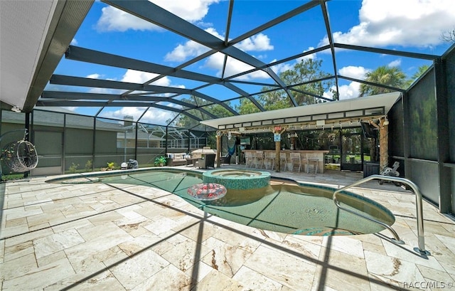 view of swimming pool featuring a patio, glass enclosure, and an outdoor bar