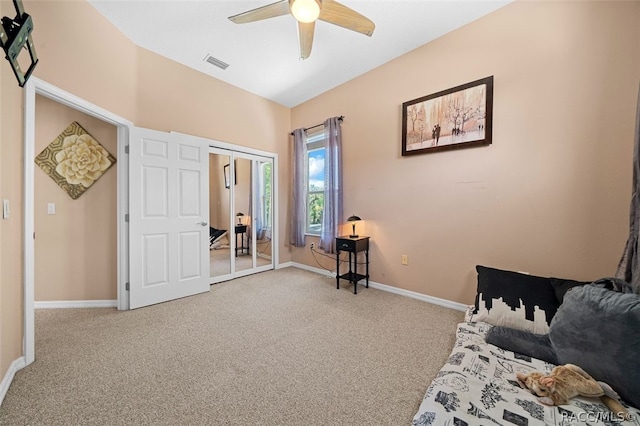 interior space with ceiling fan, a closet, and carpet floors