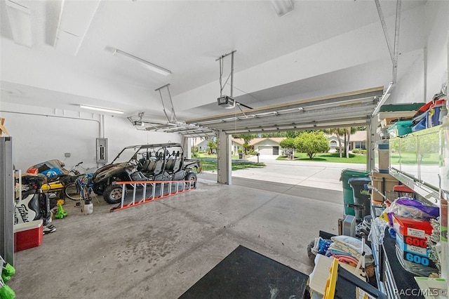 garage with electric panel and a garage door opener