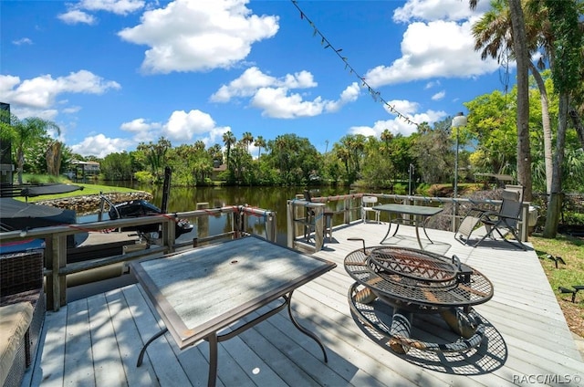 dock area featuring a water view and an outdoor fire pit