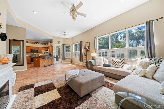 living room with ceiling fan and light tile patterned floors