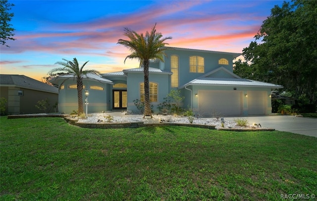 view of front facade with a lawn and a garage