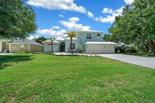 view of front of property featuring a front lawn and a garage