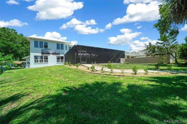 back of property featuring a lanai and a yard