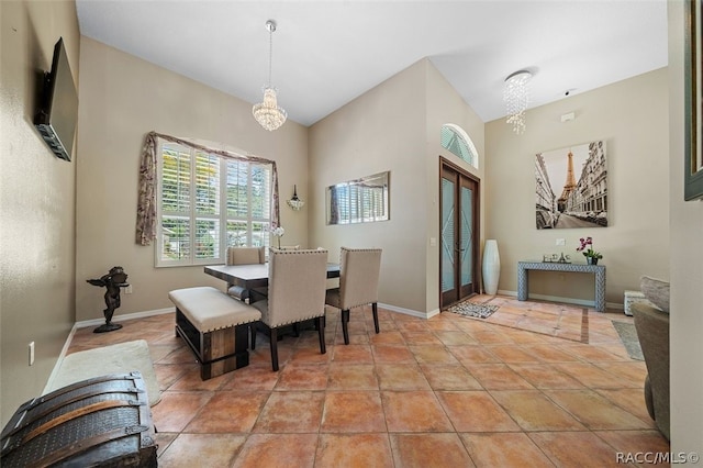 tiled dining area featuring an inviting chandelier