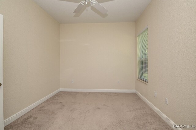 carpeted empty room with ceiling fan