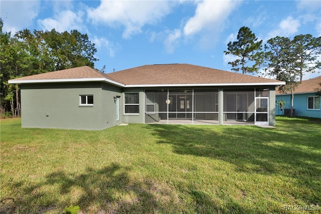 back of house with a lawn and a sunroom