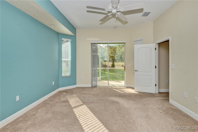 carpeted spare room with ceiling fan