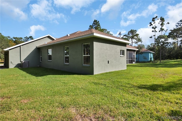 rear view of property featuring a yard