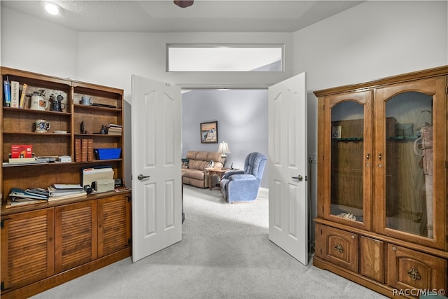 interior space featuring lofted ceiling and light carpet