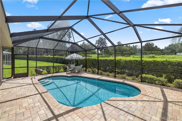 view of pool with a lanai and a patio area