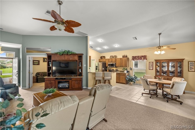 living room featuring light tile patterned floors, ceiling fan, and lofted ceiling