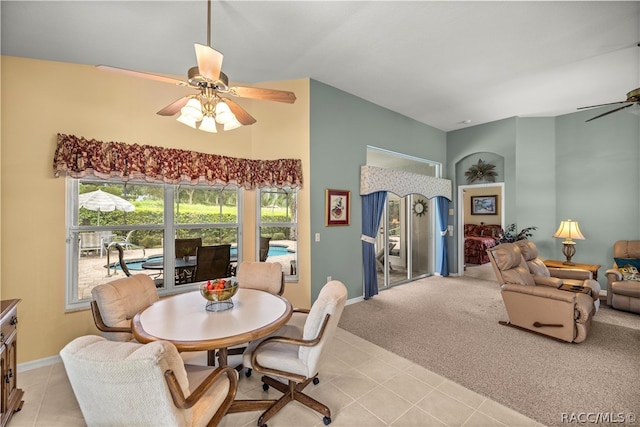 carpeted dining room with ceiling fan