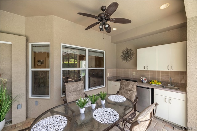 view of patio featuring ceiling fan and sink