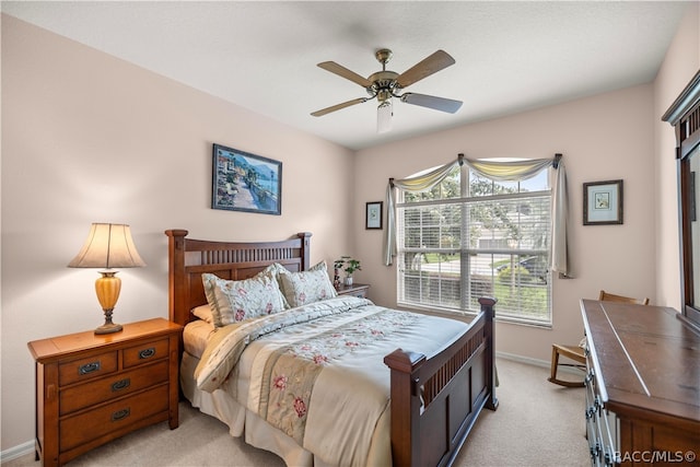 bedroom with ceiling fan and light carpet