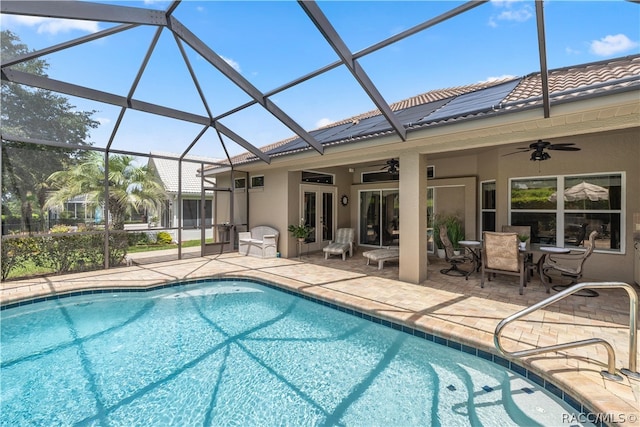 view of pool featuring ceiling fan, a patio, and glass enclosure