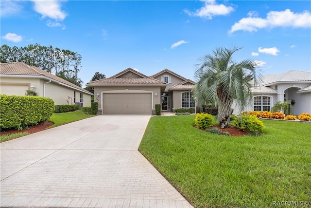 view of front of property featuring a garage and a front lawn