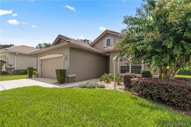 view of front of house with a garage and a front lawn