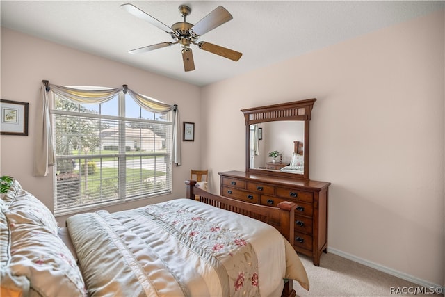 bedroom featuring light carpet and ceiling fan