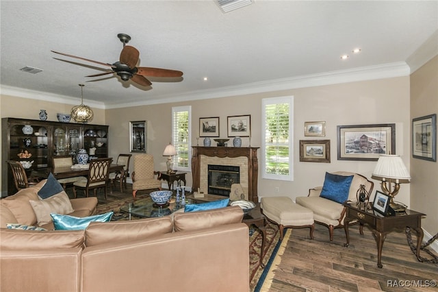 living room featuring hardwood / wood-style flooring, ceiling fan, and crown molding