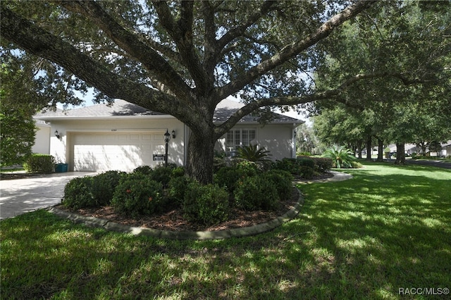 view of property exterior with a yard and a garage